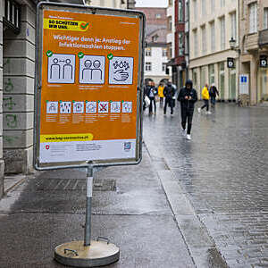 A large sign in the city centre of St Gallen, Switzerland, reminds people how to behave during the COVID-19 pandemic.